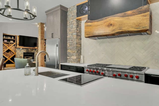 3120 Boxley View Ln, Franklin, TN 37064 - kitchen featuring exhaust hood, decorative backsplash, light countertops, high quality fridge, and a fireplace
