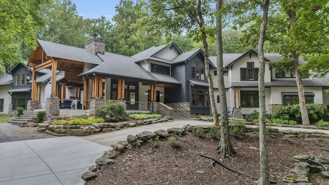 3120 Boxley View Ln, Franklin, TN 37064 - craftsman house with a porch, a chimney, stone siding, roof with shingles, and driveway