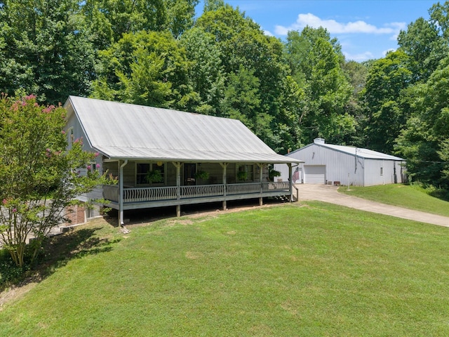 3000 Preston Bagwell Rd, Clarksville, TN 37043 - view of front of house featuring a front lawn, an outdoor structure, a garage, a porch, and a metal roof