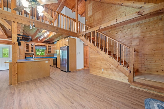 3000 Preston Bagwell Rd, Clarksville, TN 37043 - kitchen with stainless steel refrigerator with ice dispenser, wooden walls, healthy amount of natural light, light wood-style flooring, and a wooden ceiling with exposed beams