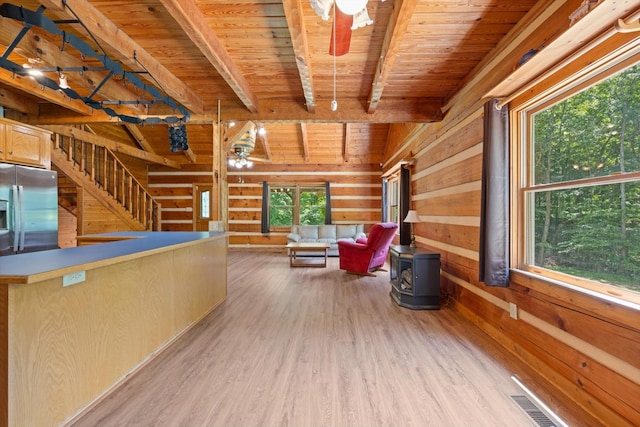 3000 Preston Bagwell Rd, Clarksville, TN 37043 - unfurnished living room featuring a wooden ceiling with exposed beams, light wood-type flooring, wooden walls, a ceiling fan, and stairs