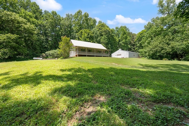 3000 Preston Bagwell Rd, Clarksville, TN 37043 - view of grassy yard with a pole building, a wooded view, and an outdoor structure