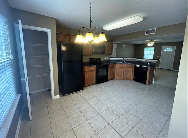 3164 Prater Ct, Murfreesboro, TN 37128 - kitchen featuring black appliances, brown cabinetry, a peninsula, light tile patterned floors, and dark countertops