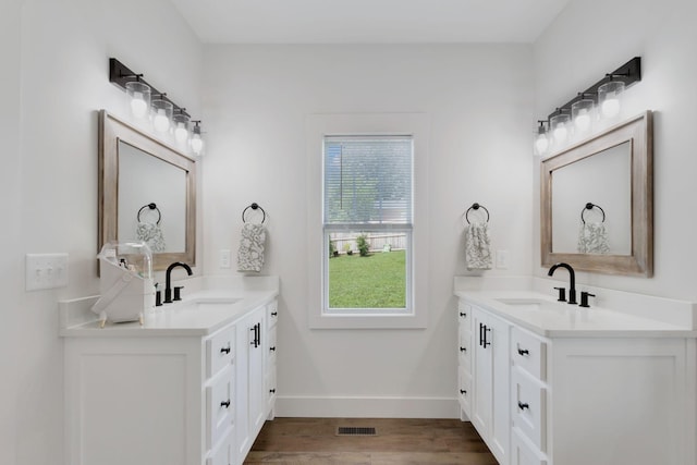 332 Country Club Rd, Winchester, TN 37398 - bathroom with two vanities, healthy amount of natural light, and wood finished floors