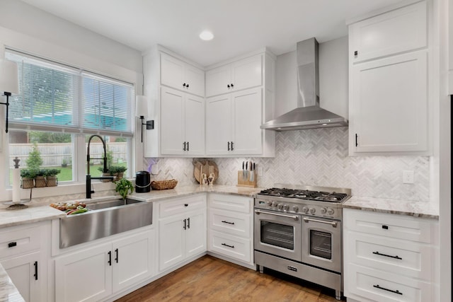 332 Country Club Rd, Winchester, TN 37398 - kitchen featuring wall chimney range hood, double oven range, healthy amount of natural light, white cabinets, and recessed lighting