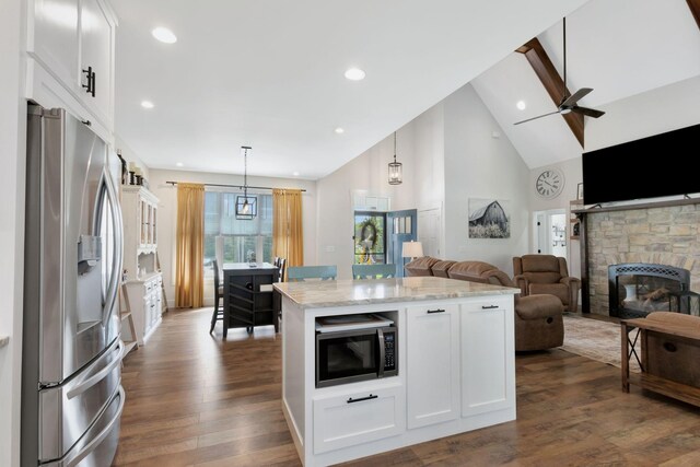 332 Country Club Rd, Winchester, TN 37398 - kitchen with stainless steel fridge with ice dispenser, open floor plan, dark wood finished floors, white cabinetry, and light stone counters