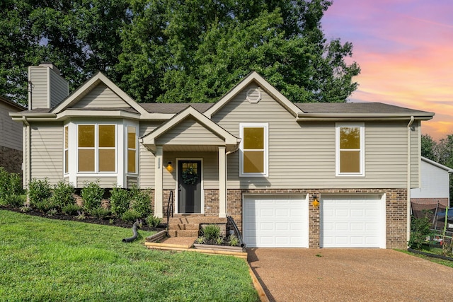 1204 Lambeth Way, Antioch, TN 37013 - raised ranch featuring brick siding, an attached garage, a front yard, concrete driveway, and a chimney