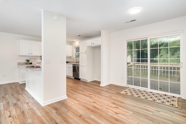 1204 Lambeth Way, Antioch, TN 37013 - kitchen featuring stainless steel dishwasher, light wood-style flooring, white cabinets, and a textured ceiling