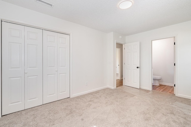 1204 Lambeth Way, Antioch, TN 37013 - unfurnished bedroom with carpet flooring, a closet, ensuite bath, and a textured ceiling