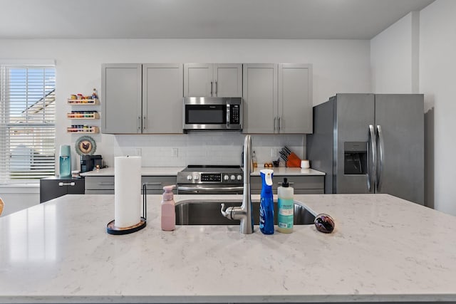 622 Birdie Dr, Spring Hill, TN 37174 - kitchen with stainless steel appliances, gray cabinets, and decorative backsplash