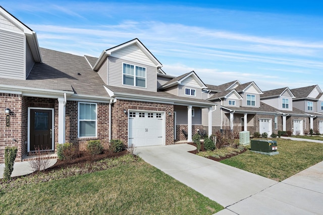 622 Birdie Dr, Spring Hill, TN 37174 - craftsman inspired home featuring driveway, brick siding, a front yard, a residential view, and a garage