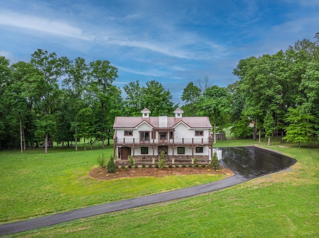 1224 Hangar Dr, Springfield, TN 37172 - view of front of home with a front yard, asphalt driveway, a balcony, and a metal roof