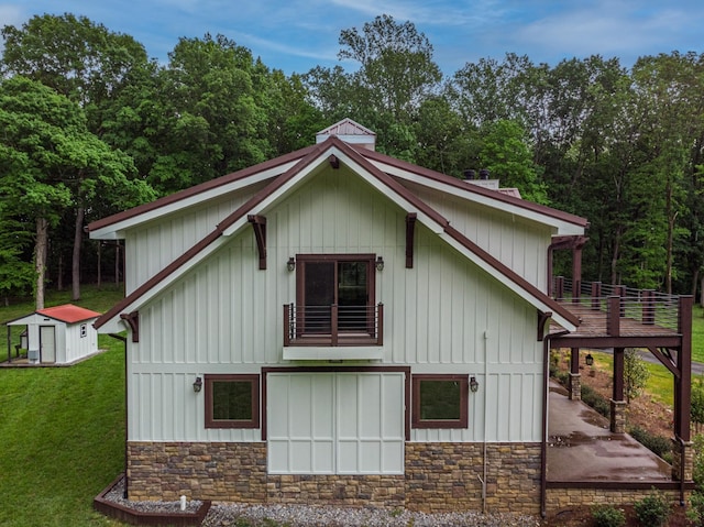 1224 Hangar Dr, Springfield, TN 37172 - view of side of home with stone siding, a lawn, an outbuilding, and board and batten siding