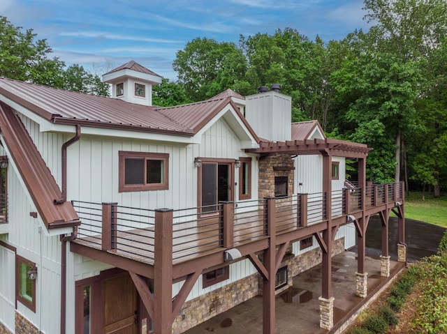 1224 Hangar Dr, Springfield, TN 37172 - rear view of property with a chimney, a metal roof, stone siding, a deck, and a patio