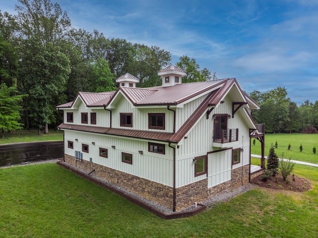 1224 Hangar Dr, Springfield, TN 37172 - view of property exterior with a yard, board and batten siding, stone siding, a metal roof, and a standing seam roof