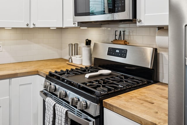 819 Woodside St, Columbia, TN 38401 - kitchen featuring stainless steel appliances, butcher block counters, white cabinetry, and tasteful backsplash