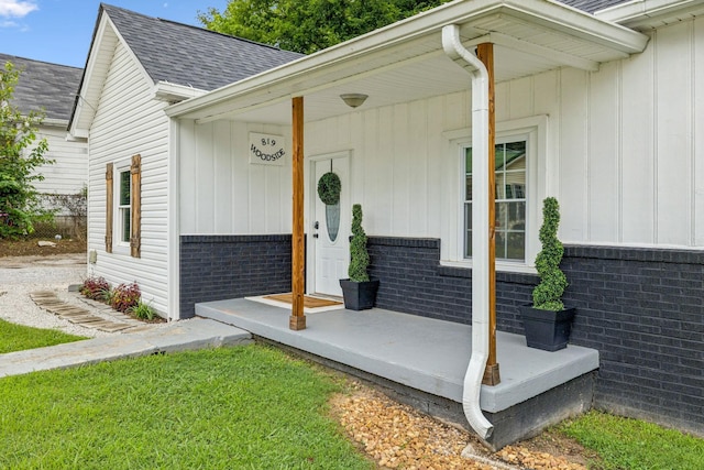 819 Woodside St, Columbia, TN 38401 - view of exterior entry featuring roof with shingles, brick siding, and covered porch