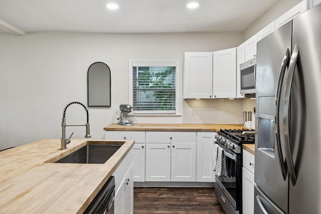 819 Woodside St, Columbia, TN 38401 - kitchen with appliances with stainless steel finishes, butcher block counters, recessed lighting, dark wood-style floors, and backsplash