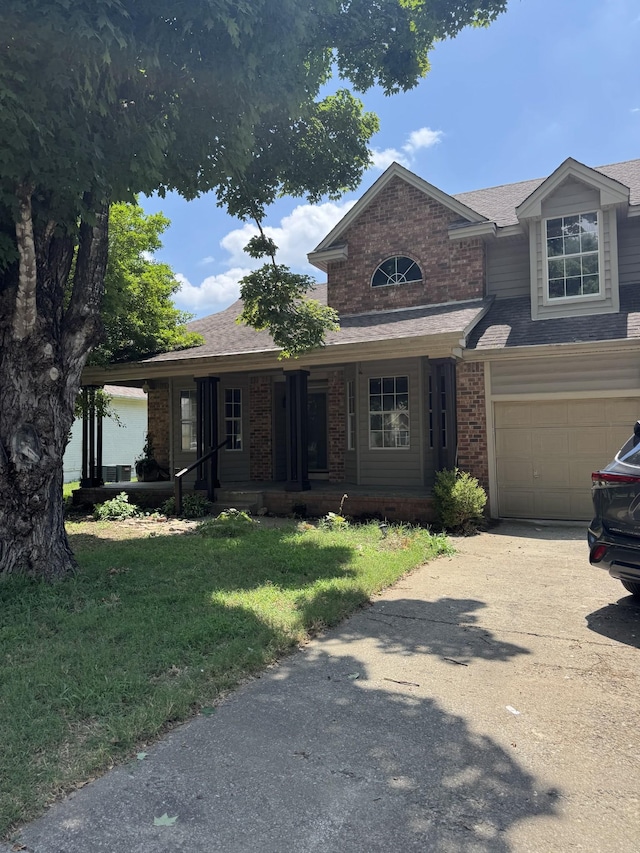 311 Park Glen Dr, Mount Juliet, TN 37122 - view of front of home with brick siding, driveway, a front yard, covered porch, and an attached garage