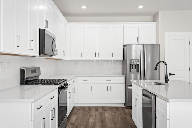4013 Norman Dr, Spring Hill, TN 37174 - kitchen with appliances with stainless steel finishes, dark wood-type flooring, tasteful backsplash, white cabinets, and recessed lighting