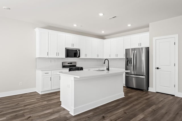 4013 Norman Dr, Spring Hill, TN 37174 - kitchen with appliances with stainless steel finishes, dark wood-style floors, light countertops, white cabinets, and recessed lighting