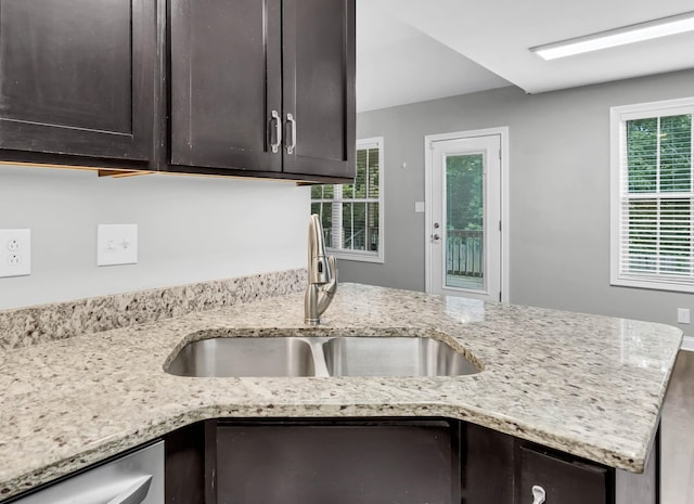 626 Snowshoe Ln, Clarksville, TN 37040 - kitchen with dark brown cabinetry, light stone countertops, and dishwasher