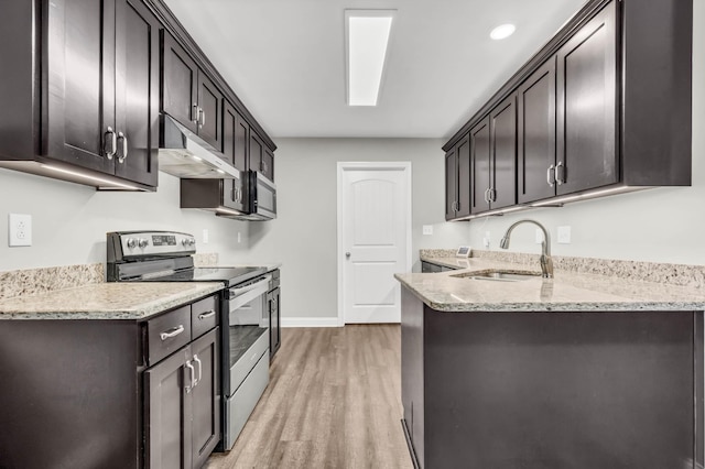 626 Snowshoe Ln, Clarksville, TN 37040 - kitchen featuring electric range, light wood-style flooring, under cabinet range hood, light stone countertops, and a peninsula