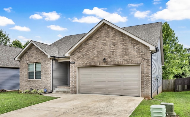 626 Snowshoe Ln, Clarksville, TN 37040 - single story home featuring brick siding, a garage, concrete driveway, and roof with shingles