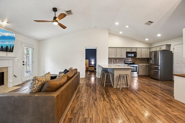 3315 Monoco Dr, Spring Hill, TN 37174 - living room featuring lofted ceiling, dark wood finished floors, a ceiling fan, a premium fireplace, and recessed lighting