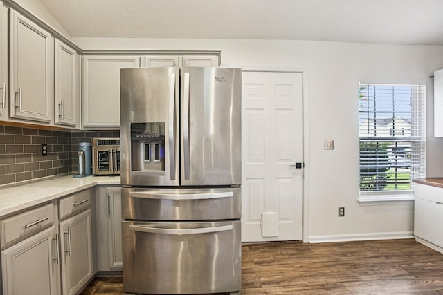 3315 Monoco Dr, Spring Hill, TN 37174 - kitchen with stainless steel fridge with ice dispenser, gray cabinets, dark wood finished floors, decorative backsplash, and light stone countertops
