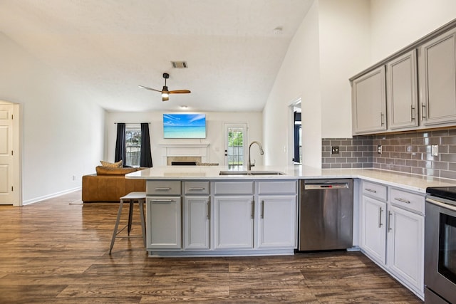 3315 Monoco Dr, Spring Hill, TN 37174 - kitchen featuring stainless steel appliances, a peninsula, gray cabinets, open floor plan, and ceiling fan