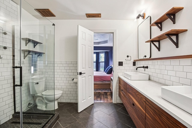 3315 Monoco Dr, Spring Hill, TN 37174 - bathroom with double vanity, a stall shower, tile walls, ensuite bath, and tile patterned flooring