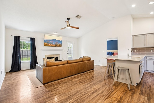 3315 Monoco Dr, Spring Hill, TN 37174 - living area with vaulted ceiling, healthy amount of natural light, a fireplace, wood finished floors, and recessed lighting