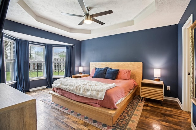 3315 Monoco Dr, Spring Hill, TN 37174 - bedroom featuring a raised ceiling, hardwood / wood-style floors, a textured ceiling, and a ceiling fan