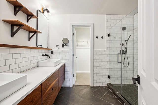 3315 Monoco Dr, Spring Hill, TN 37174 - full bathroom with a shower stall, double vanity, a walk in closet, and tasteful backsplash