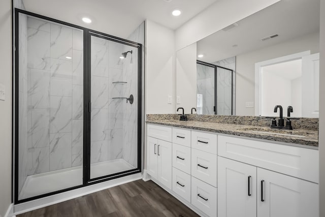 4005 Norman Dr, Spring Hill, TN 37174 - full bathroom with a marble finish shower, double vanity, wood finished floors, and recessed lighting
