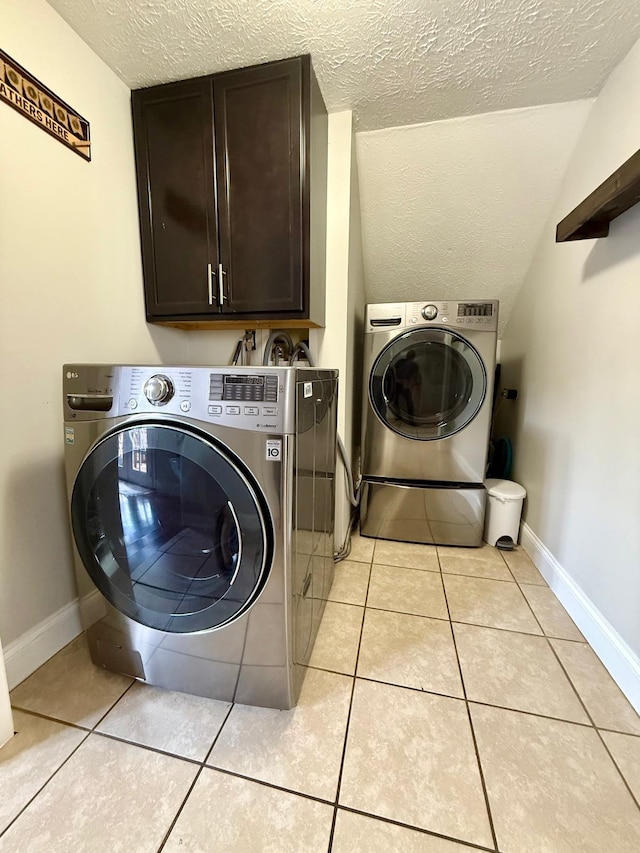 231 Overlook Pl, Columbia, TN 38401 - laundry area featuring cabinet space, washer and clothes dryer, a textured ceiling, and light tile patterned floors