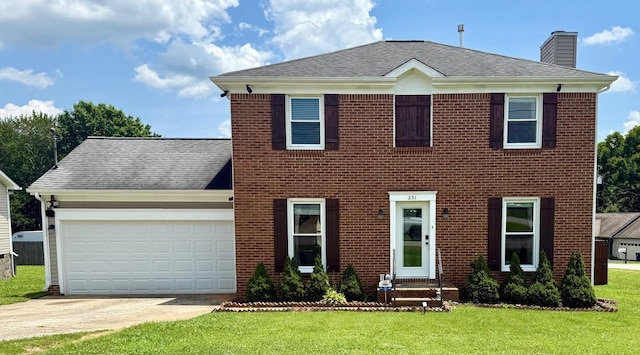 231 Overlook Pl, Columbia, TN 38401 - colonial-style house featuring a chimney, a front lawn, concrete driveway, an attached garage, and a shingled roof