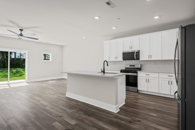 4009 Norman Dr, Spring Hill, TN 37174 - kitchen featuring appliances with stainless steel finishes, tasteful backsplash, a ceiling fan, dark wood-style floors, and light countertops