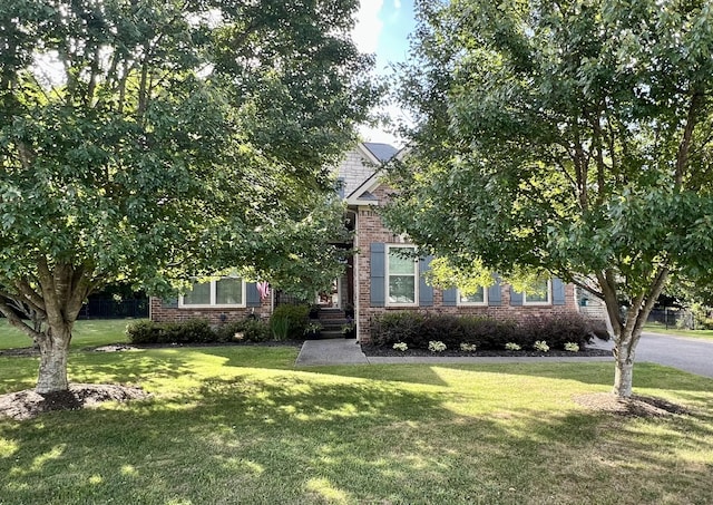 1401 Round Hill Ln, Spring Hill, TN 37174 - obstructed view of property with a front yard and brick siding