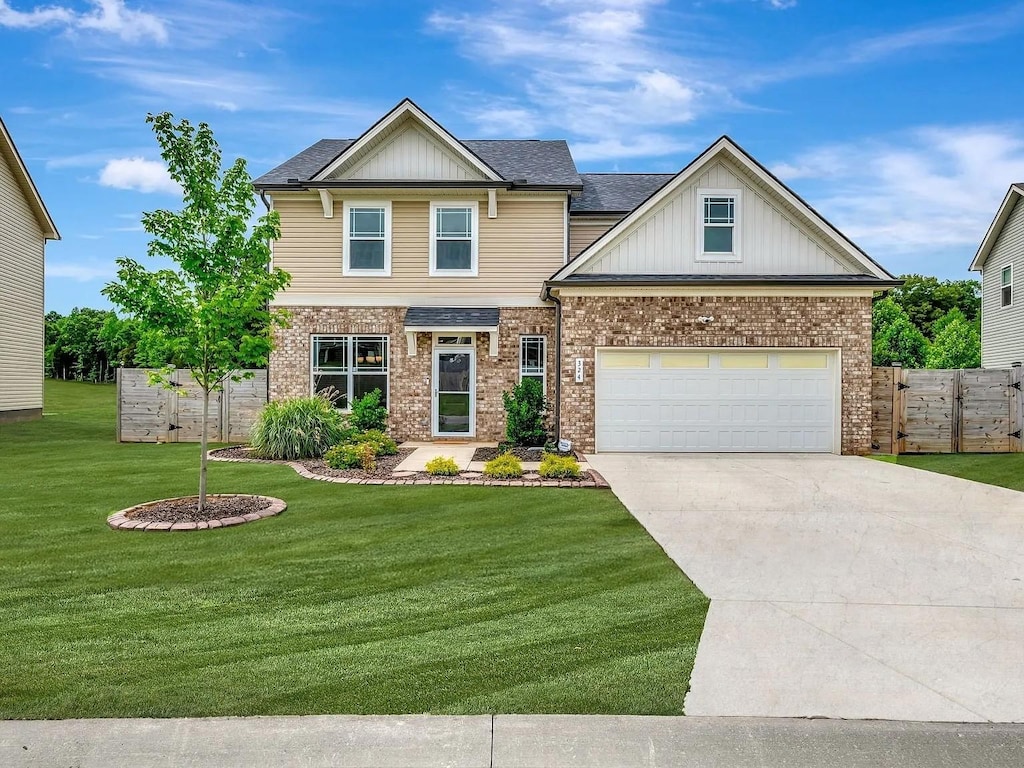 324 Wyburn Pl NE, Burns, TN 37029 - craftsman-style home with driveway, brick siding, a garage, and board and batten siding