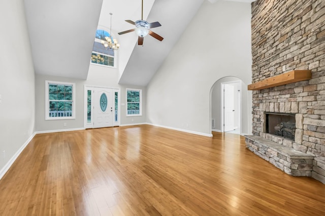 3190 Marthas Chapel Rd, Cunningham, TN 37052 - unfurnished living room featuring high vaulted ceiling, ceiling fan, a fireplace, wood finished floors, and arched walkways