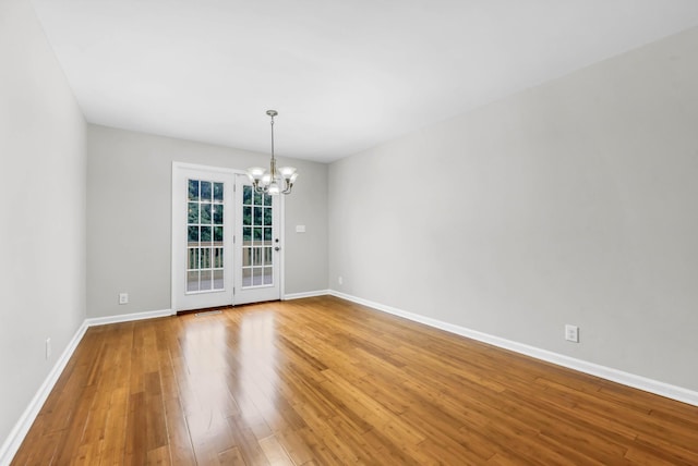 3190 Marthas Chapel Rd, Cunningham, TN 37052 - spare room with a chandelier and wood finished floors