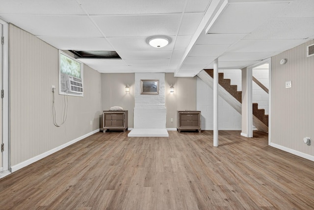 609 Chrisman Dr, Clarksville, TN 37042 - below grade area featuring light wood-type flooring, stairway, a wall unit AC, and wooden walls