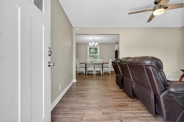 609 Chrisman Dr, Clarksville, TN 37042 - living room with light wood-type flooring, ceiling fan, and a chandelier