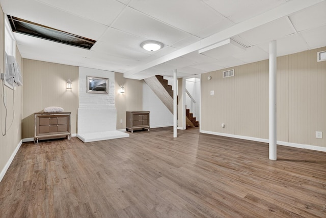 609 Chrisman Dr, Clarksville, TN 37042 - finished below grade area featuring stairway, wood finished floors, a drop ceiling, and an AC wall unit