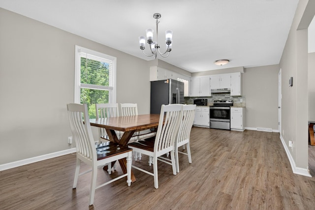 609 Chrisman Dr, Clarksville, TN 37042 - dining room with a chandelier and light wood finished floors
