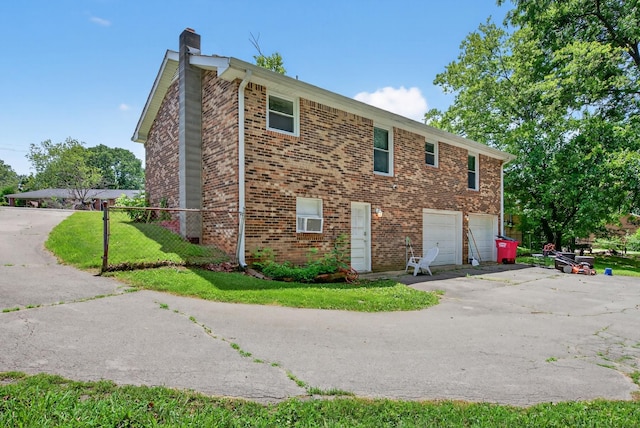 609 Chrisman Dr, Clarksville, TN 37042 - view of side of property with a garage, a chimney, driveway, and brick siding