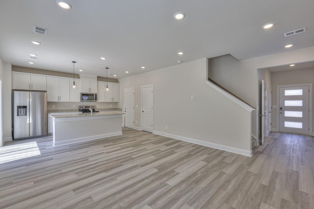 1753 Flora Grv, Hermitage, TN 37076 - kitchen with appliances with stainless steel finishes, white cabinetry, light wood-style flooring, light countertops, and recessed lighting