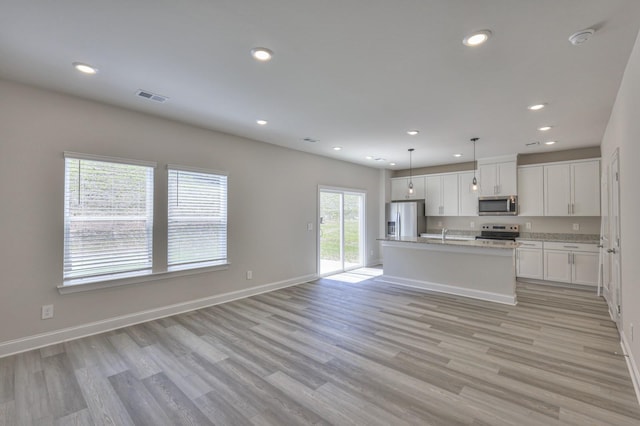 1753 Flora Grv, Hermitage, TN 37076 - kitchen with stainless steel appliances, light wood-style flooring, recessed lighting, white cabinets, and open floor plan